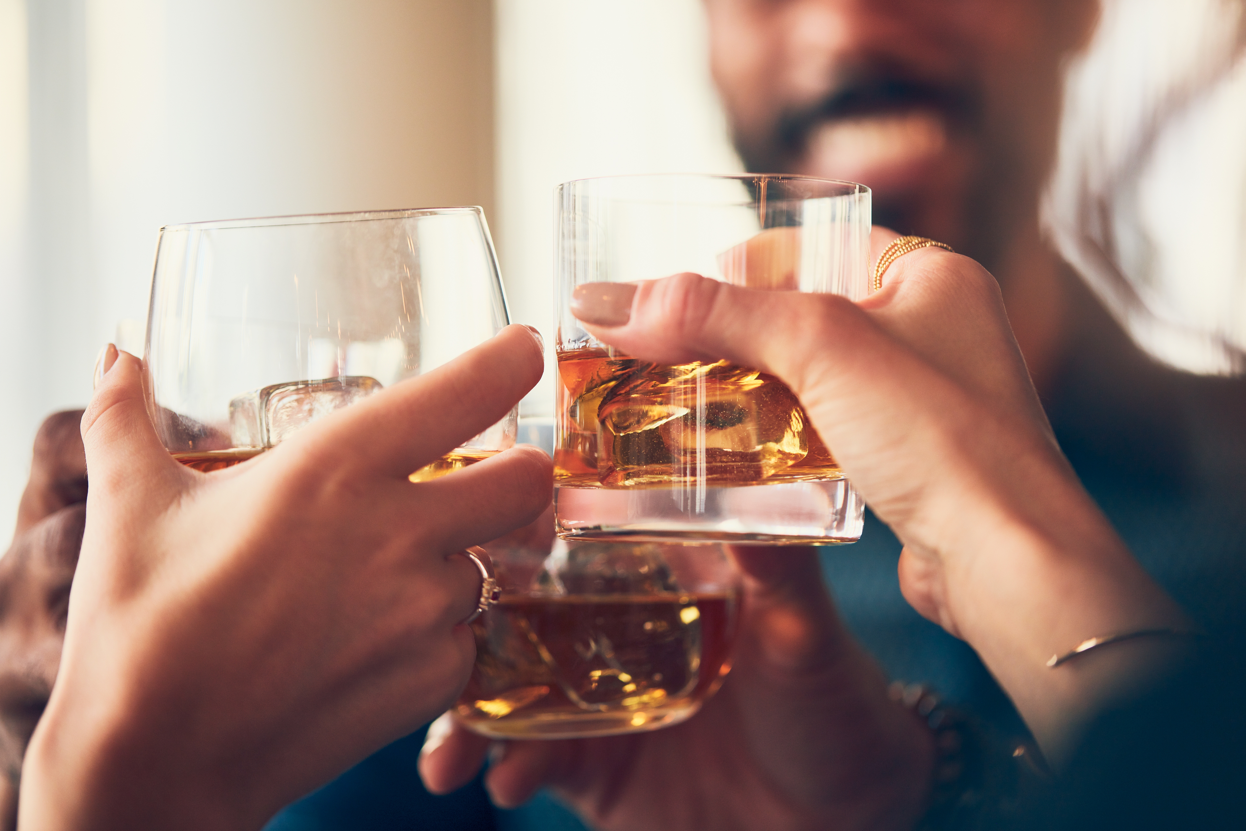 closeup-shot-many-people-clinking-glasses-with-alcohol-toast