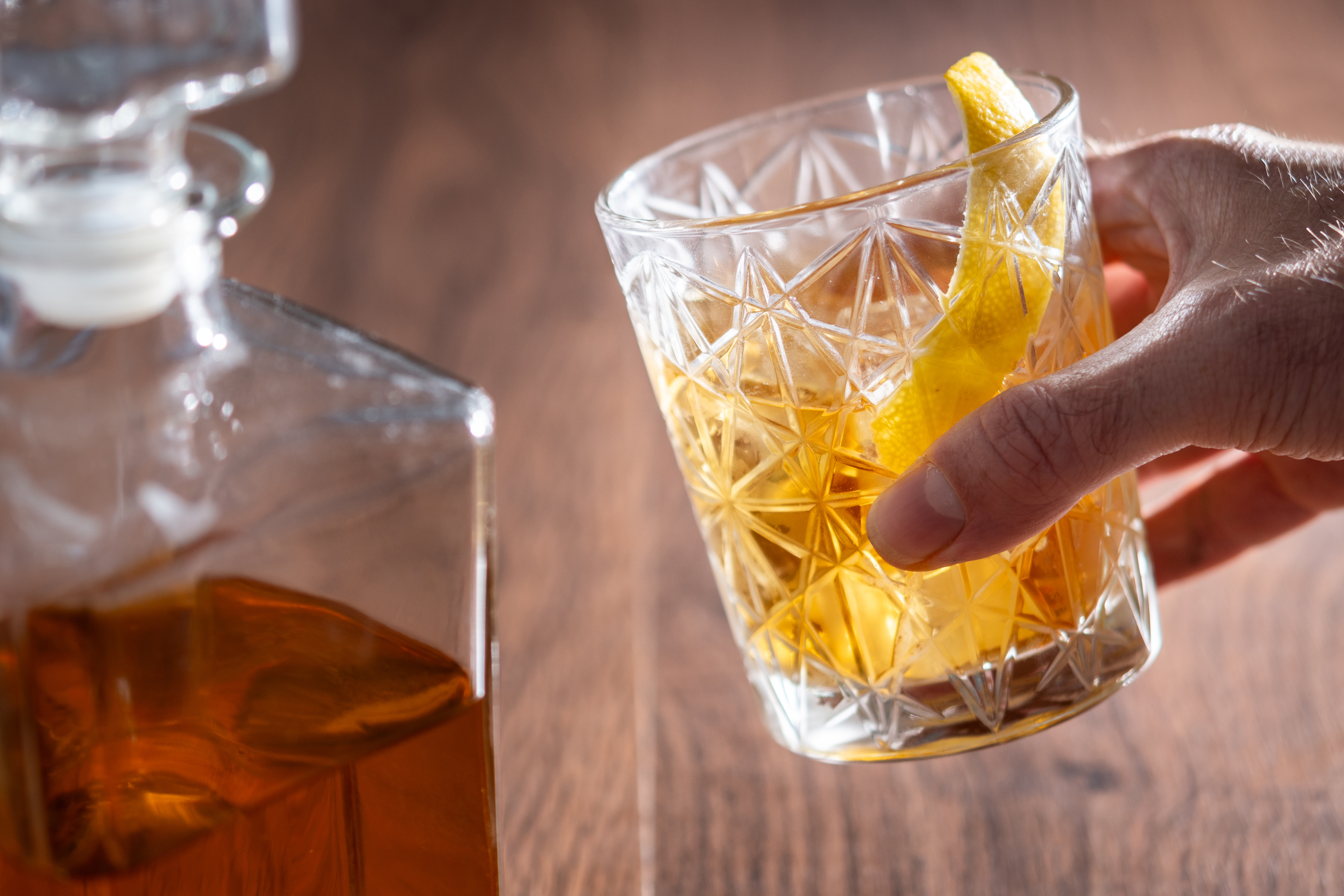 hand-picking-up-rusty-nail-cocktail-glass